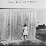 Young-girl-facing-wooden-fence